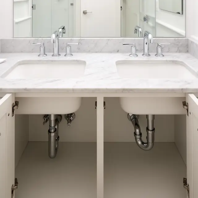 Double vanity with marble countertop and chrome P-trap plumbing in Sandy OR – Efficiency Plumbing