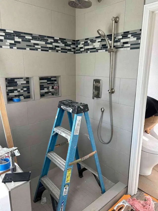 Custom tile shower with dual shower heads and built-in niches in Boring OR – Efficiency Plumbing