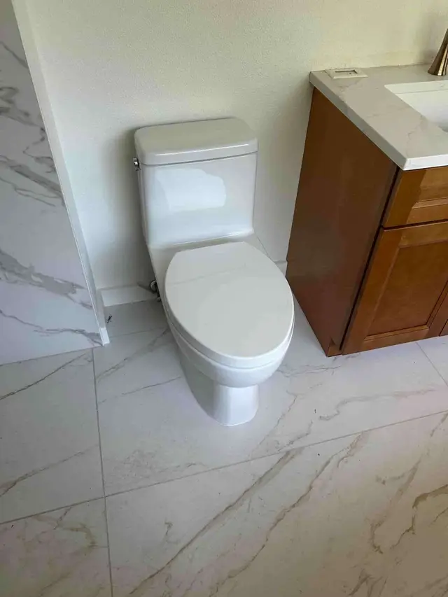 New toilet installation with marble tile flooring in Sandy OR – Efficiency Plumbing